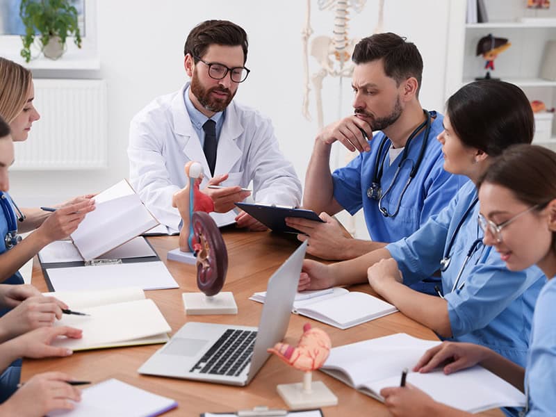 A group of physicians in a meeting dicussing how to prepare for the shift to value-based care in their organization.